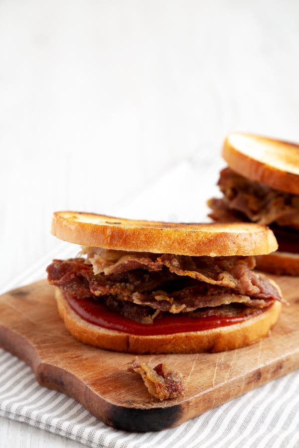 Homemade British Bacon Sandwich on a Rustic Wooden Board, Side View
