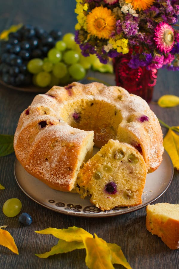 Autumn grapes fruit cake in rustic decor. Homemade bundtcake with autumn grapes on a table with fall decoration royalty free stock photos Autumn grapes fruit cake in rustic decor. Homemade bundtcake with autumn grapes on a table with fall decoration royalty free stock photos