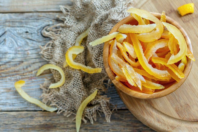 Homemade candied citrus and old sacking on a wooden table. Homemade candied citrus and old sacking on a wooden table.