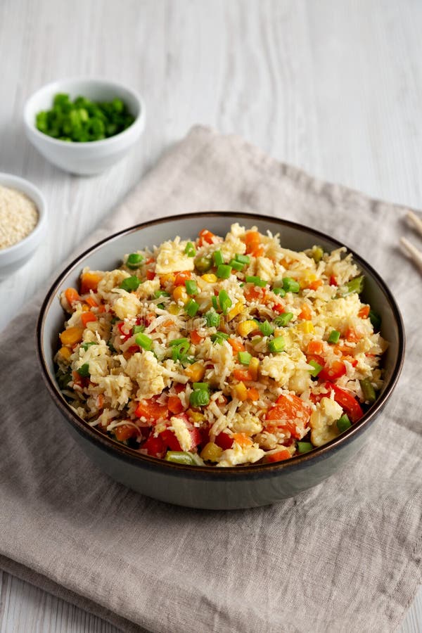Homemade Cauliflower Fried Rice with Chives and Sesame Seeds in a Bowl