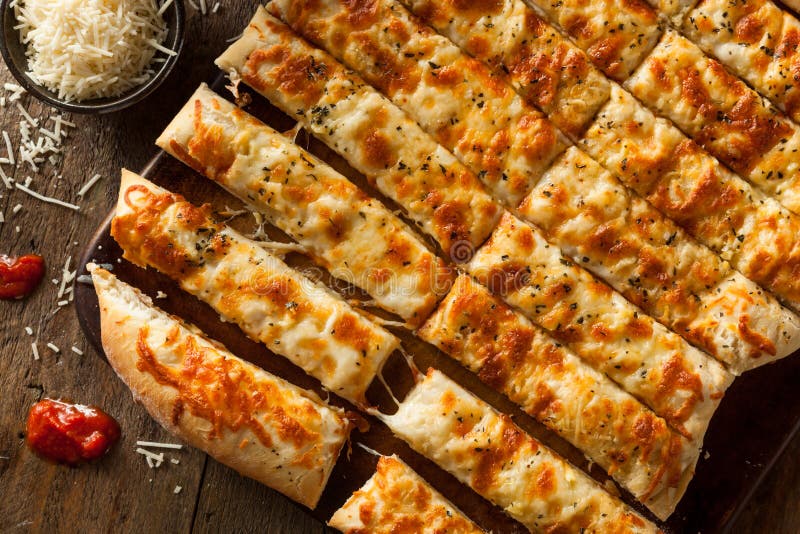 Homemade Cheesy Breadsticks with Marinara royalty free stock photos