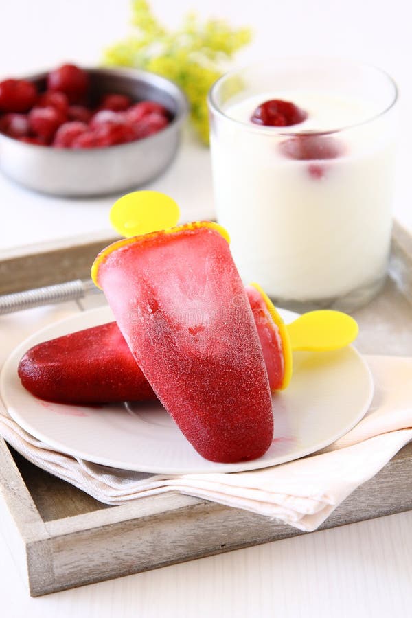 Homemade cherry ice cream popsicle with yogurt.