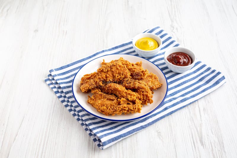 Homemade Chicken Strips with Mustard and BBQ on a Plate, Side View