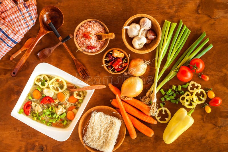 Homemade chicken vegetable soup, overhead view. Chicken soup with rice noodles. Fresh vegetables for soup. Diet food royalty free stock images Homemade chicken vegetable soup, overhead view. Chicken soup with rice noodles. Fresh vegetables for soup. Diet food royalty free stock images