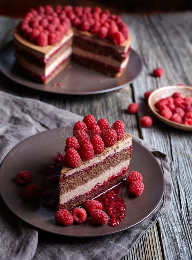 Homemade chocolate cake mousse cheesecake with fresh raspberries on the rustic wooden table. stock photos