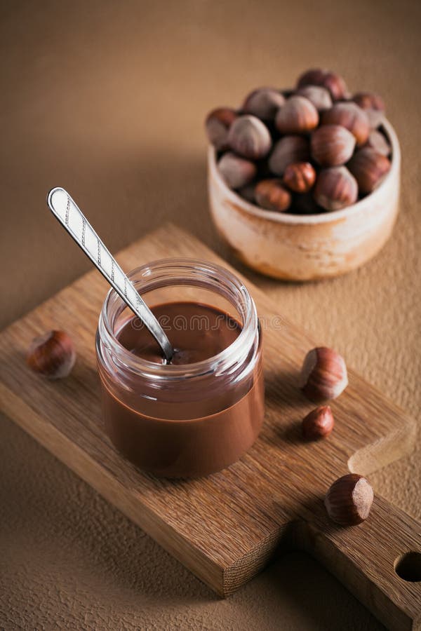 Homemade Chocolate Hazelnut Milk Spread on a Brown Background Stock
