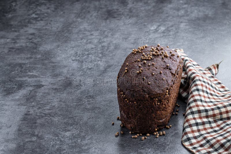 Homemade Dark Rye Bread with Coriander Seeds on Gray Stone Background
