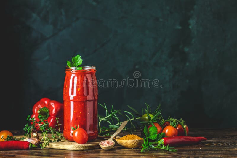 Homemade DIY natural canned hot tomato sauce chutney with chilli or adjika