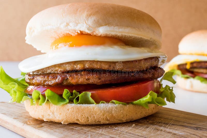 Homemade Double Hamburger with Egg, Lettuce and Tomatoes. Stock Image ...