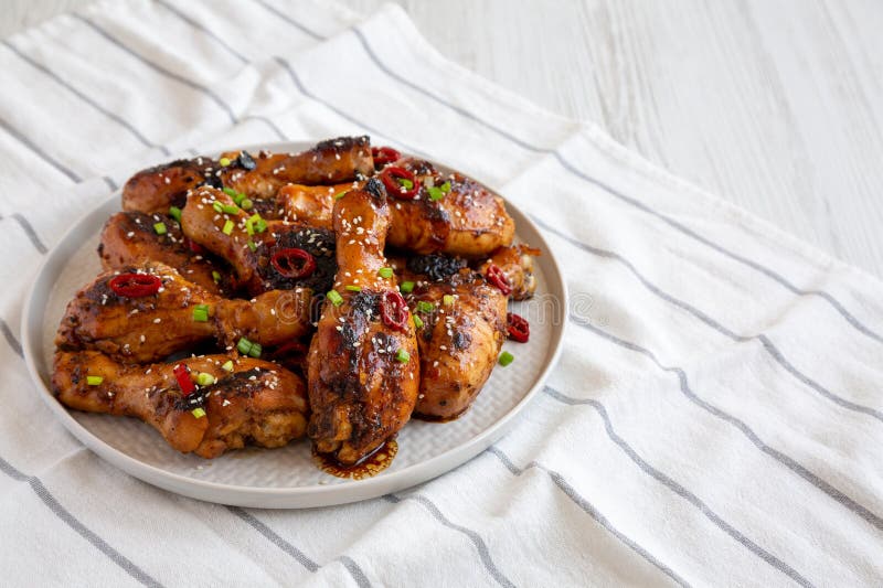 Homemade Easy Sticky Chicken Drumsticks on a Plate, Side View. Space