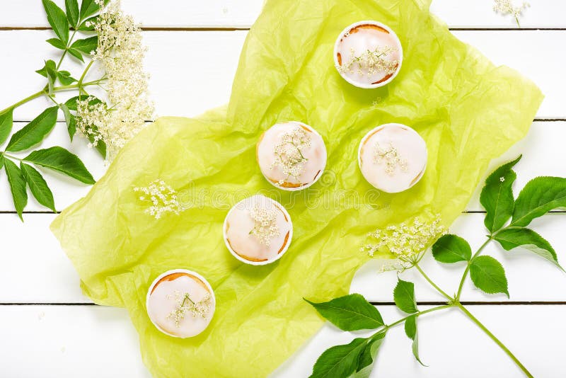 Homemade elderberry blossom muffins with sugar icing and fresh elder flowers. royalty free stock photo Homemade elderberry blossom muffins with sugar icing and fresh elder flowers. royalty free stock photo