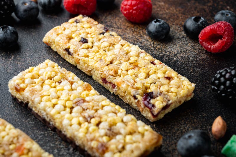 Homemade Granola Bars with Mixed Nuts, Seeds, Berries, on Old Dark