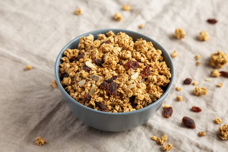 Homemade Granola with Raisins and Almonds in a Bowl, Side View Stock