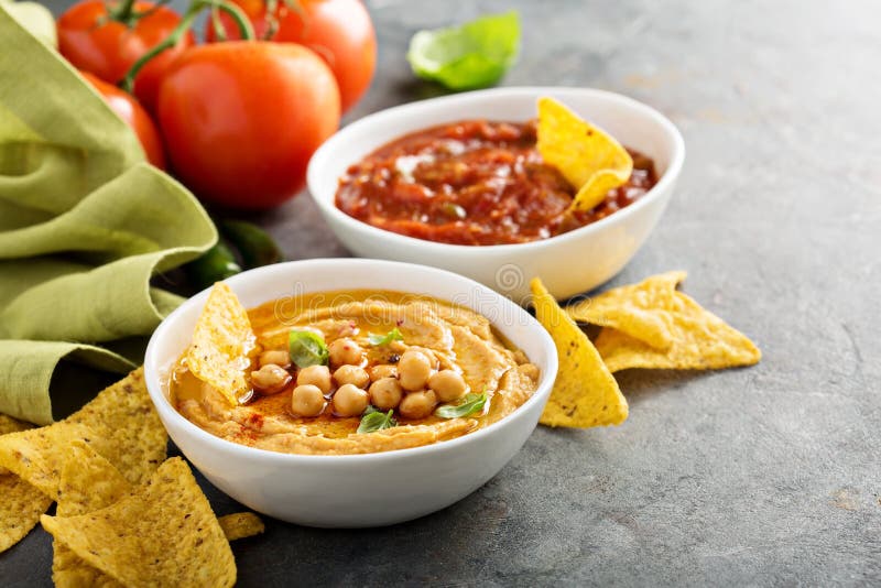 Homemade Hummus and Tomato Salsa in White Bowls with Chips Stock Photo