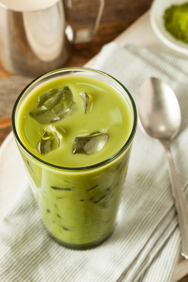 Iced Matcha Latte or Green Milk Tea in Plastic Glass Isolated on White