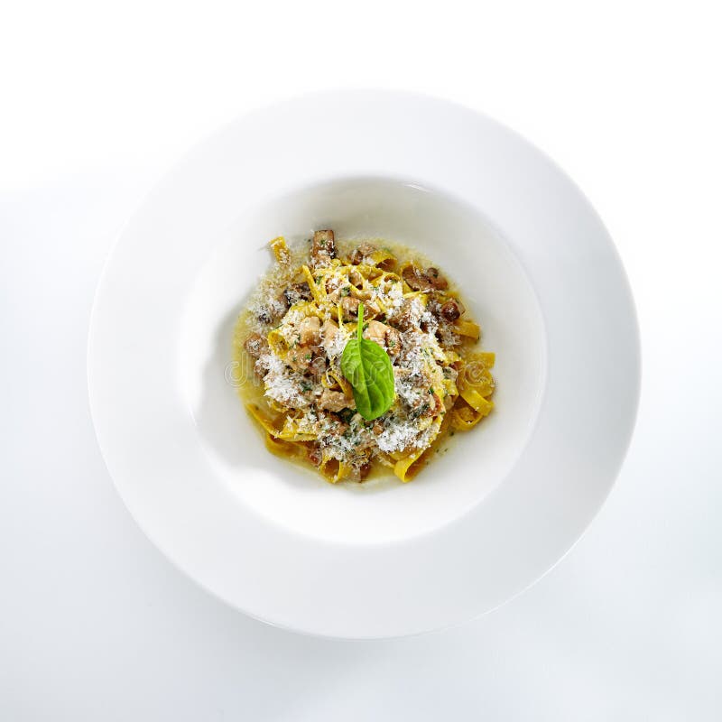 Homemade Italian Tagliatelle with Mushroom Stew and Truffles Isolated on White Background. Restaurant Main Course with Italian Pasta, White Mushrooms, Onion, Garlic, Sauce and Parsley Top View