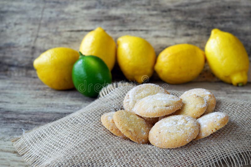 Homemade lemon cookies with lemons in the back