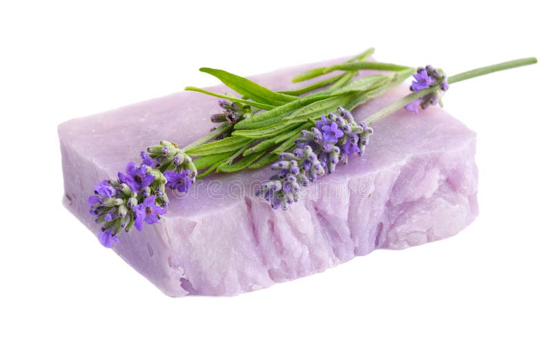 Homemade lilac lavender soap with lavender flowers atop.