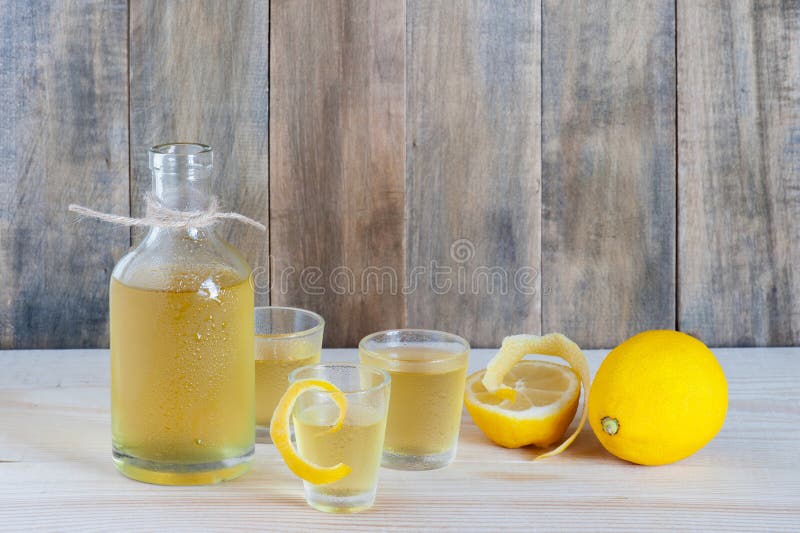 Homemade limoncello on the wooden table royalty free stock photography Homemade limoncello on the wooden table royalty free stock photography