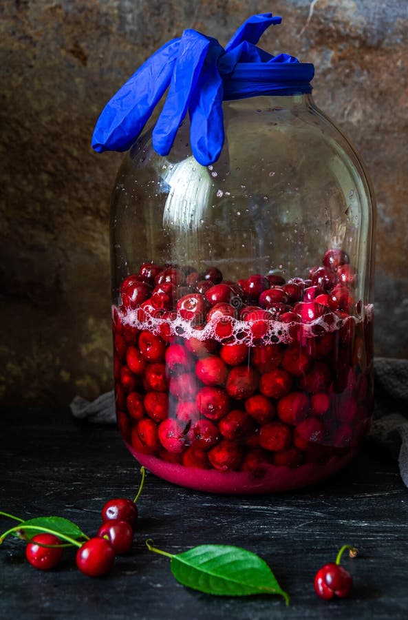 Homemade Liqueur from Cherries in a Jar of a Natural Fermentation