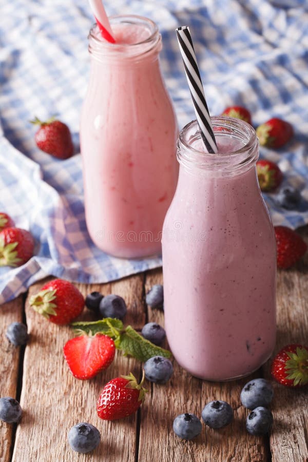 Homemade Milkshake with Strawberries and Blueberries in Bottles Stock