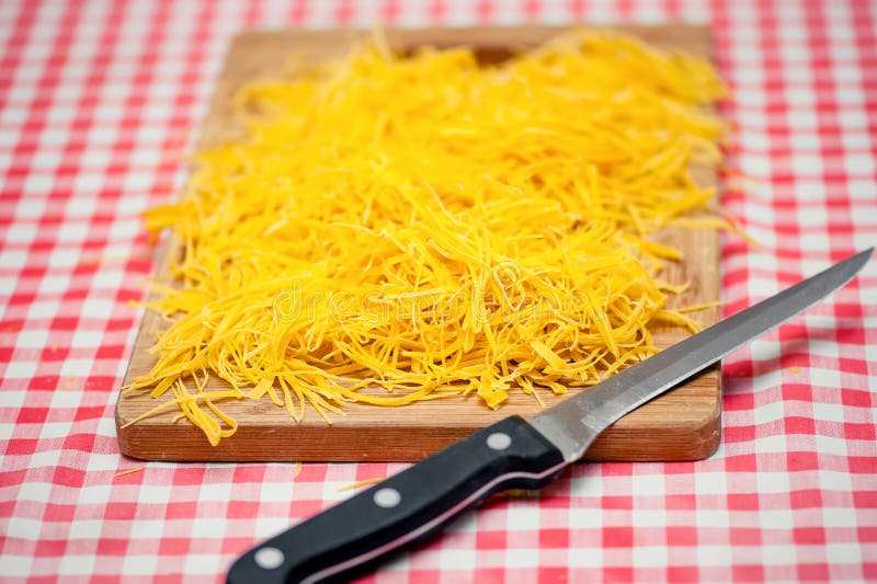 Homemade Noodles and Pasta with Knife Against Tablecloth Stock Image