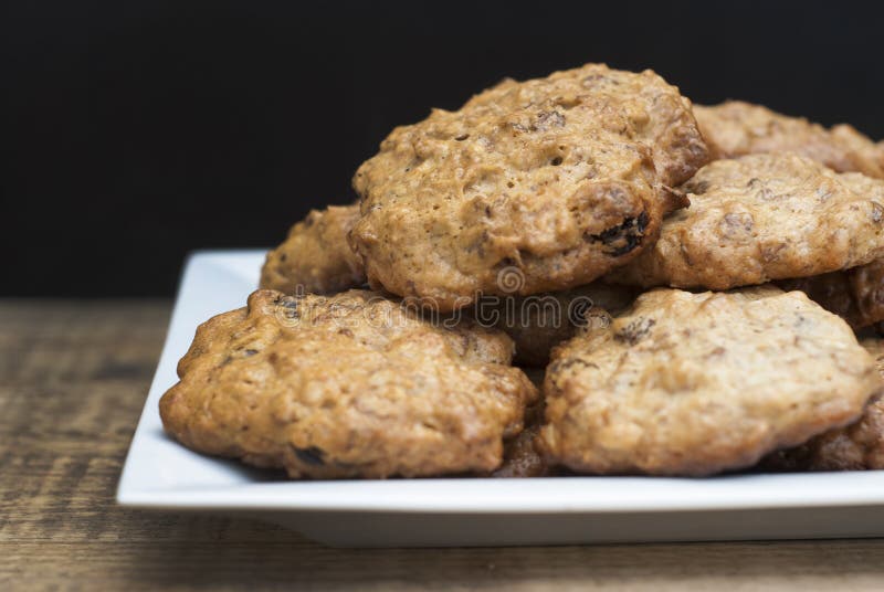 Homemade oatmeal cookies in white square plate,on wooden board and Black background. Sweet dessert snack, Healthy Food. Copy space stock photos Homemade oatmeal cookies in white square plate,on wooden board and Black background. Sweet dessert snack, Healthy Food. Copy space stock photos