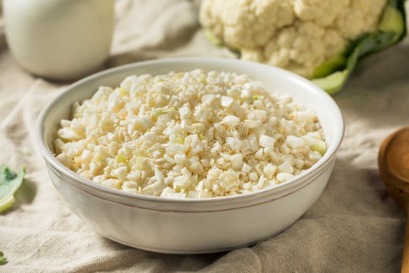 Homemade Organic Raw Cauliflower Rice in a Bowl. Paleo cauliflower stock images, royalty-free photos and pictures
