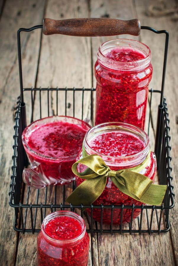 Homemade Organic Red Raspberry Jam on a wooden tab