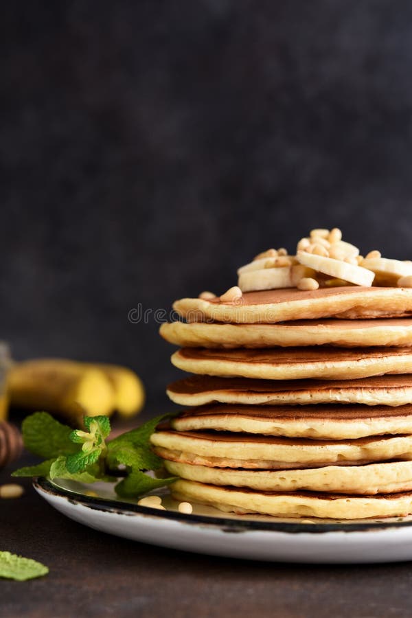 Homemade Pancakes with Banana and Pine Nuts on a Dark Background Stock ...