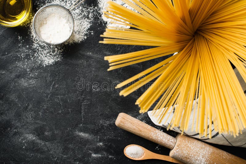 Homemade pasta spaghetti making background on black texture royalty free stock photos