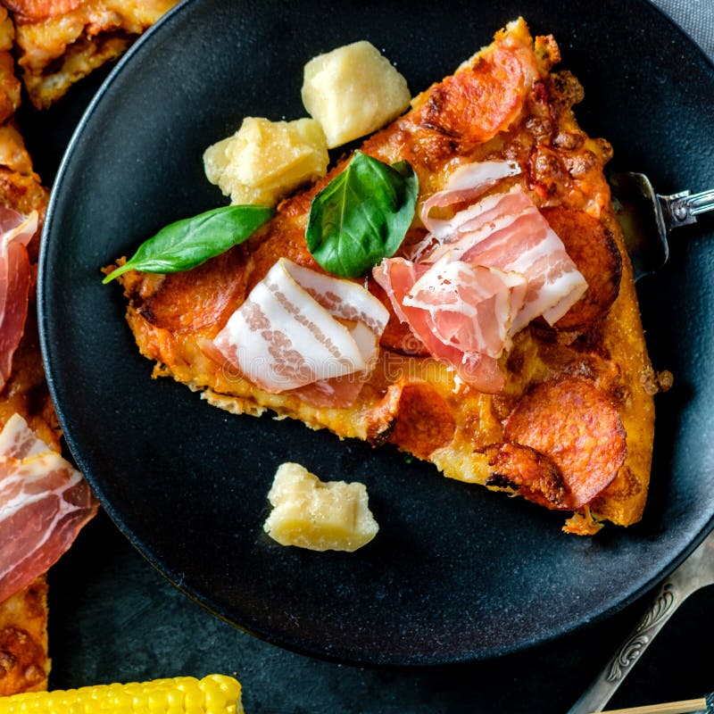 Homemade Pepperoni Pizza with Fresh Bacon Over Black Background Stock