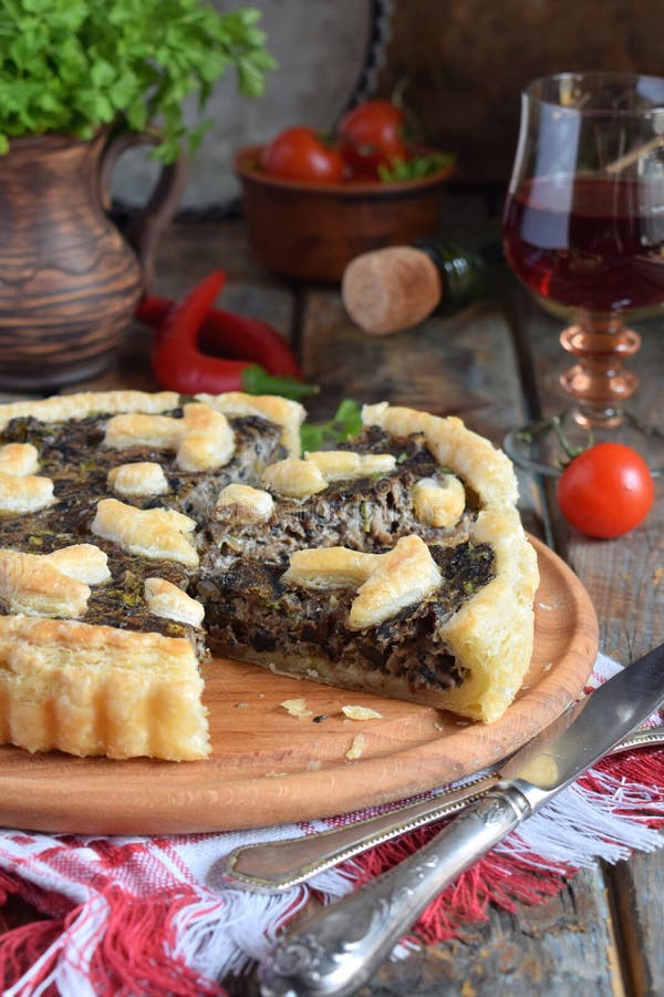 Homemade pie with mushrooms and herbs. Quiche on wooden background. Vegetarian food. stock images Homemade pie with mushrooms and herbs. Quiche on wooden background. Vegetarian food. stock images