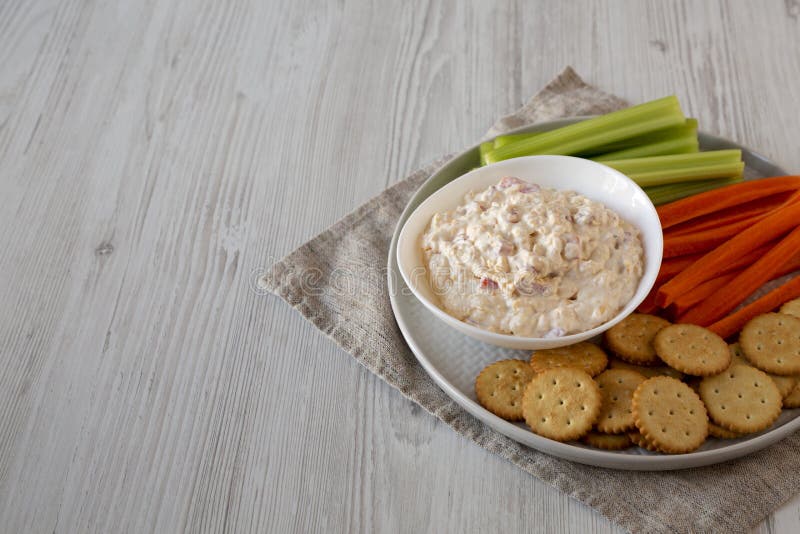 Homemade Pimento Cheese Dip with Carrots, Celery and Crackers, Side View. Copy Space Stock Photo