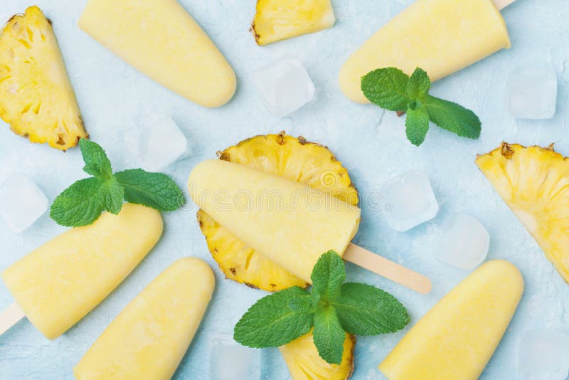 Homemade pineapple ice cream or popsicles top view. Summer refreshing sweets. Frozen fruit pulp.