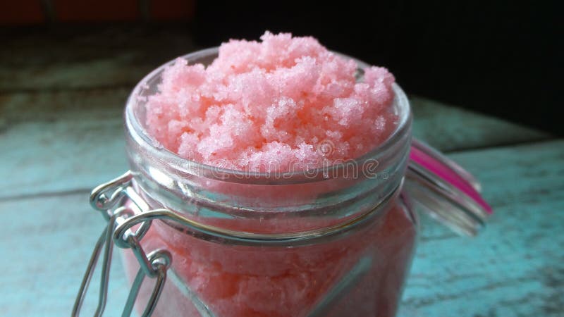 Homemade pink grapefruit sugar scrub in a glass jar. Homemade pink grapefruit sugar scrub in a glass jar.