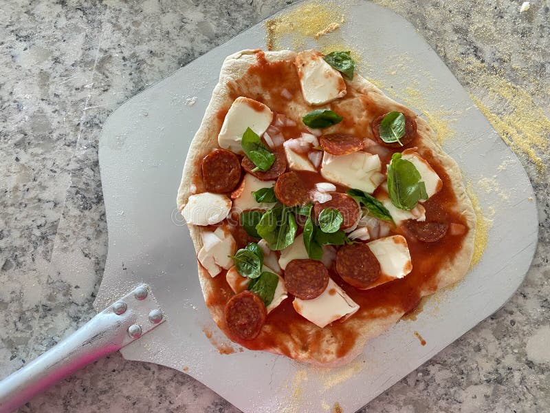 Homemade Pizza on a Pizza Peel in a Kitchen Stock Photo Image of