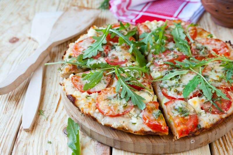 Homemade pizza with tomatoes, cheese and arugula royalty free stock photo Homemade pizza with tomatoes, cheese and arugula royalty free stock photo