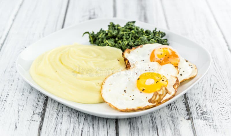 Homemade Potato Mash with Fried Eggs and Spinach Stock Image - Image of