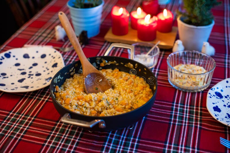 Pumpkin risotto served with pan on dining table royalty free stock photography Pumpkin risotto served with pan on dining table royalty free stock photography