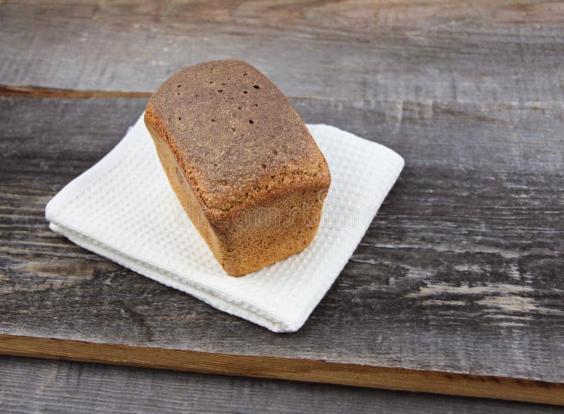 Homemade Sourdough Bread with Crisp Crust on Rough Board Background ... image