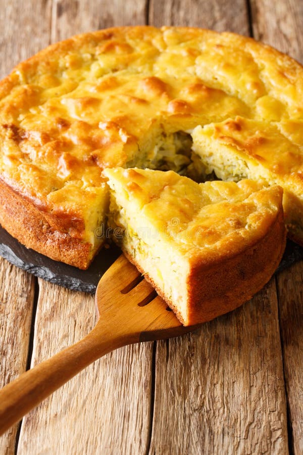 Homemade sliced cabbage pie with herbs and boiled eggs close-up. vertical stock image