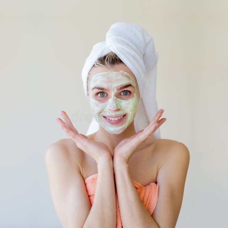 Homemade Spa Procedure Smiling Woman With A Towel Puts A Cream On Her