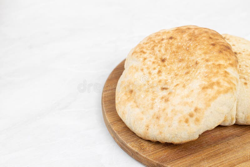 Homemade traditional lepinja bread on the wooden board