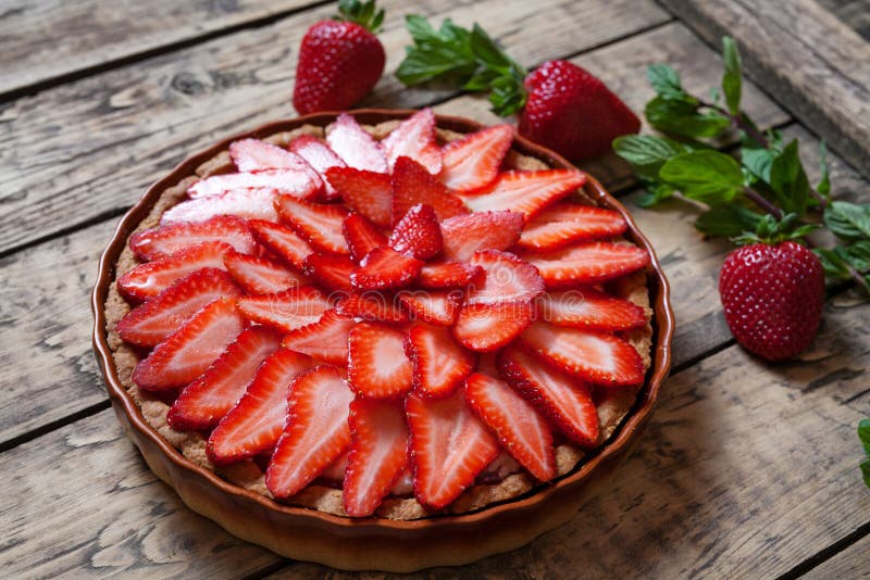 Homemade traditional strawberry tart with mint leaves