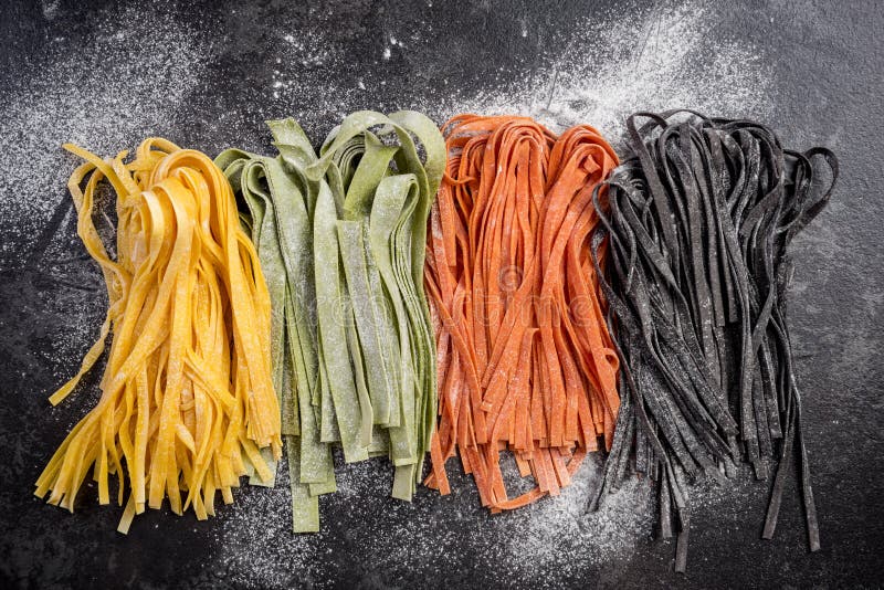 Homemade uncooked colorful tagliatelle pasta