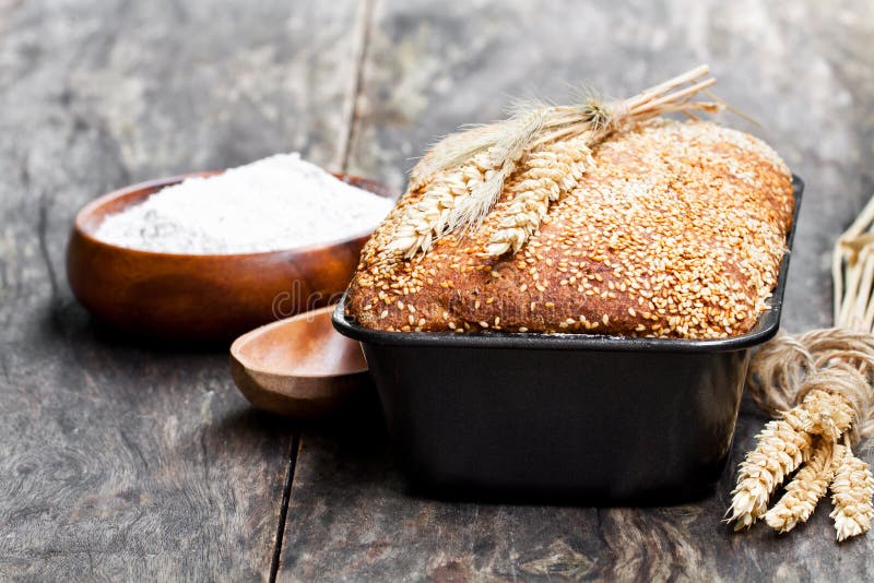 Homemade Wholemeal Rye Bread in Baking Form on Wooden Table Stock Image