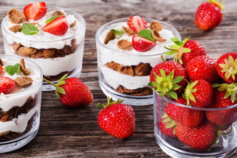 Yogurt in Cups with Whole Grain Cereals Flakes and Raspberry Stock