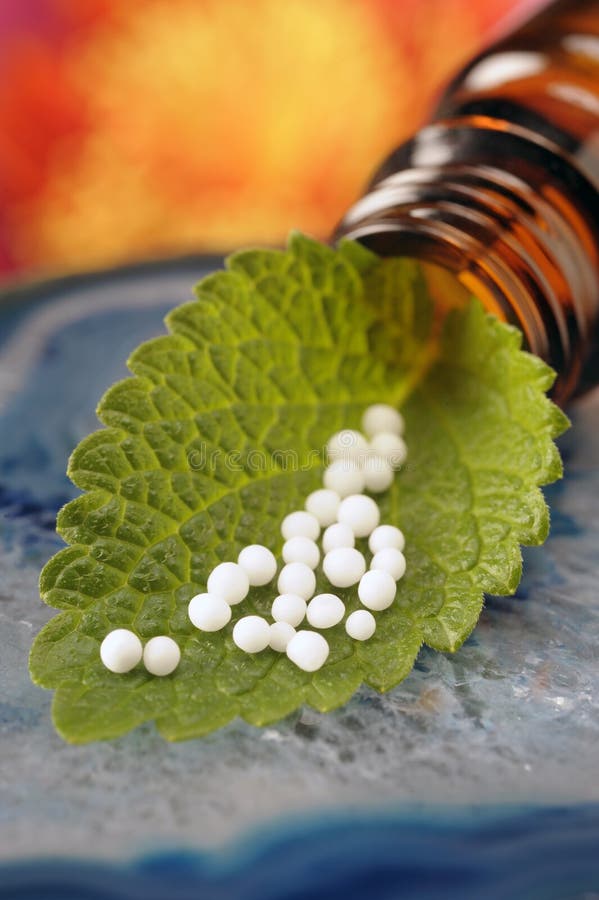 Homeopathy with herbal globules on leaf. Green herbal drug medicine stock images, royalty-free photos and pictures