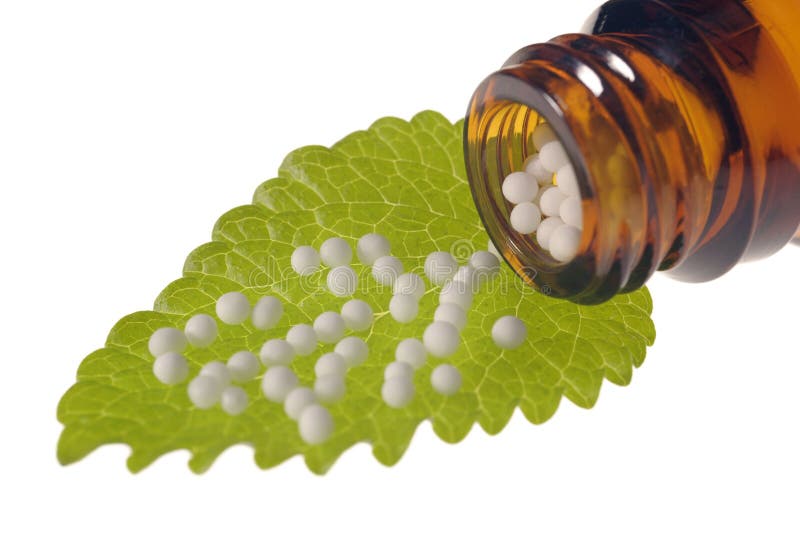 Homeopathy with herbal globules on leaf. Green herbal drug medicine stock images, royalty-free photos and pictures